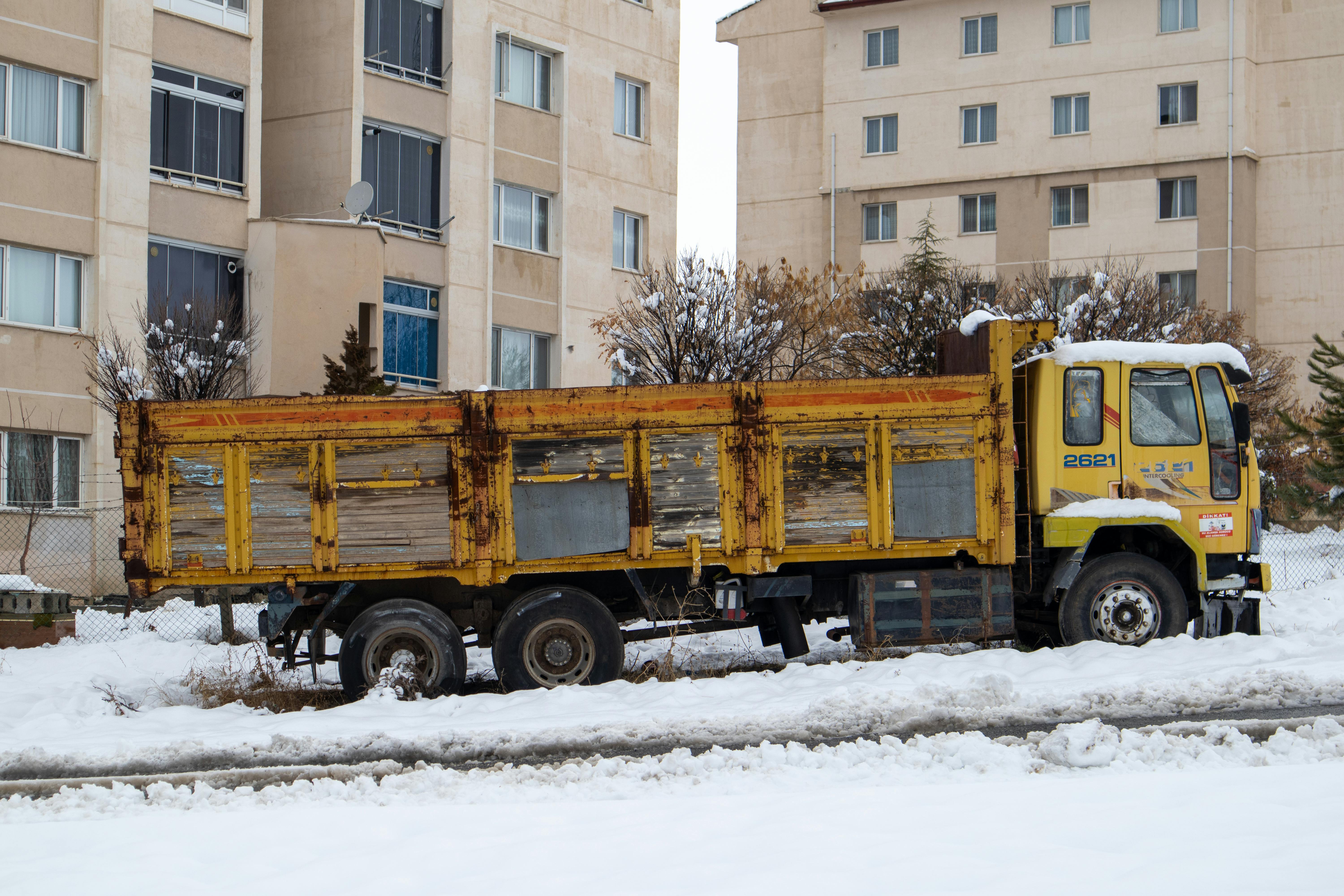 A tonneau cover shedding snow on a parked truck