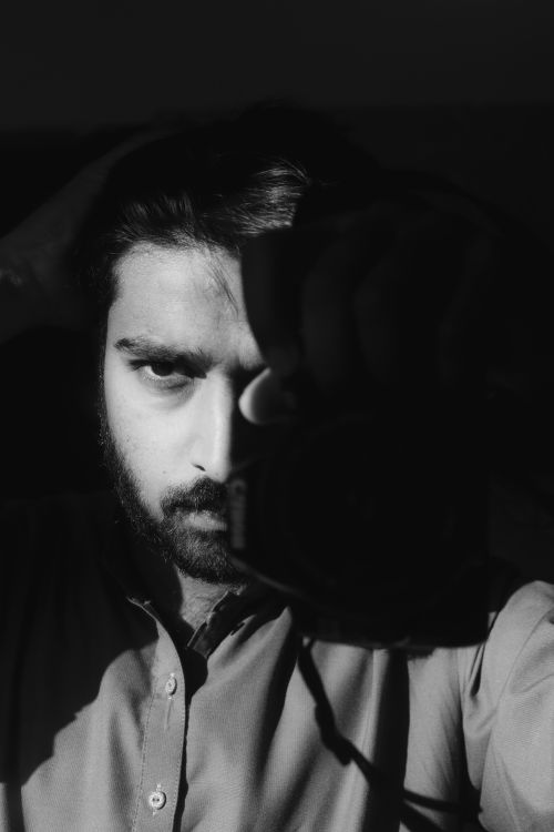 Free Dramatic black and white self-portrait showcasing emotional depth and artistic expression. Stock Photo