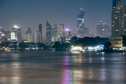 Free A vibrant view of Bangkok's skyline at night featuring the iconic Mahanakhon Tower. Stock Photo