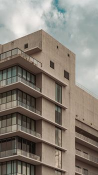 Capture of a modern building in Miami, showcasing architectural geometry against cloudy skies.