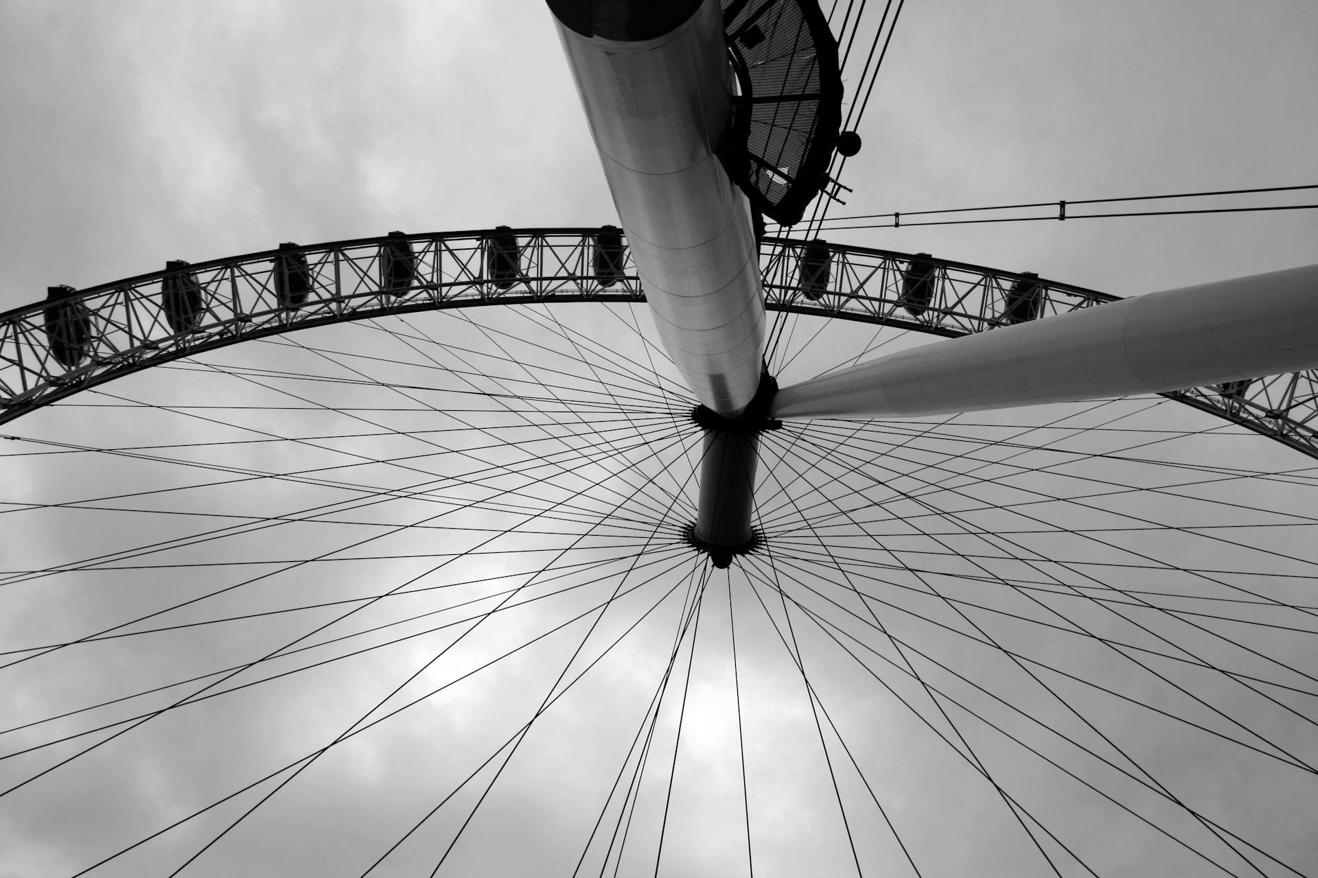 Artistic view of the London Eye with clouds, capturing its architectural elegance. Ideal for travel or urban themes.