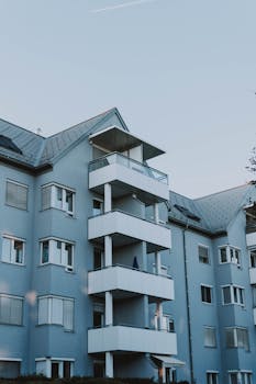 Contemporary architecture of an apartment building with balconies against a clear sky.