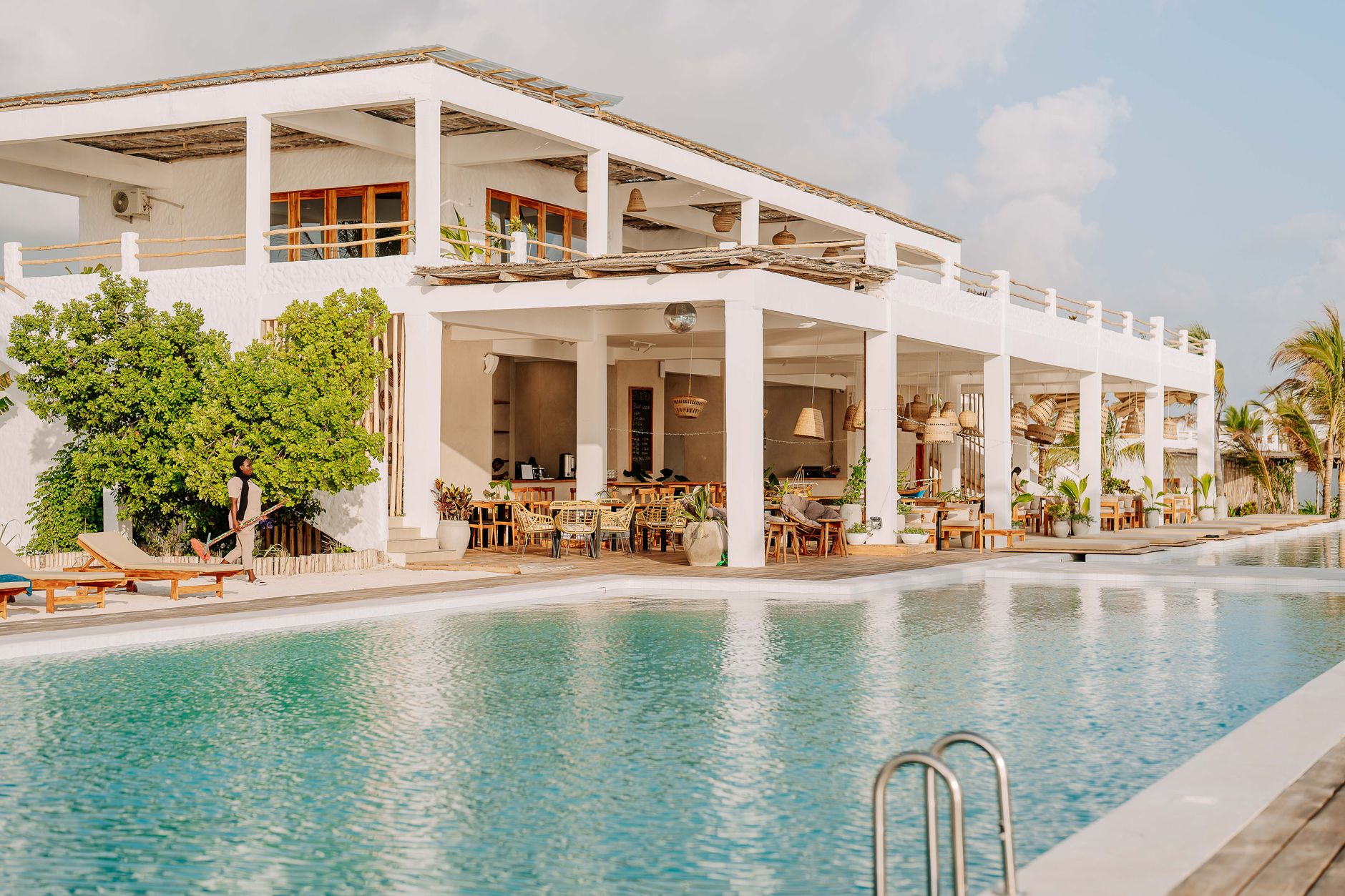 Modern beachfront resort with pool in Jambiani, Tanzania, showcasing tropical luxury and relaxation.