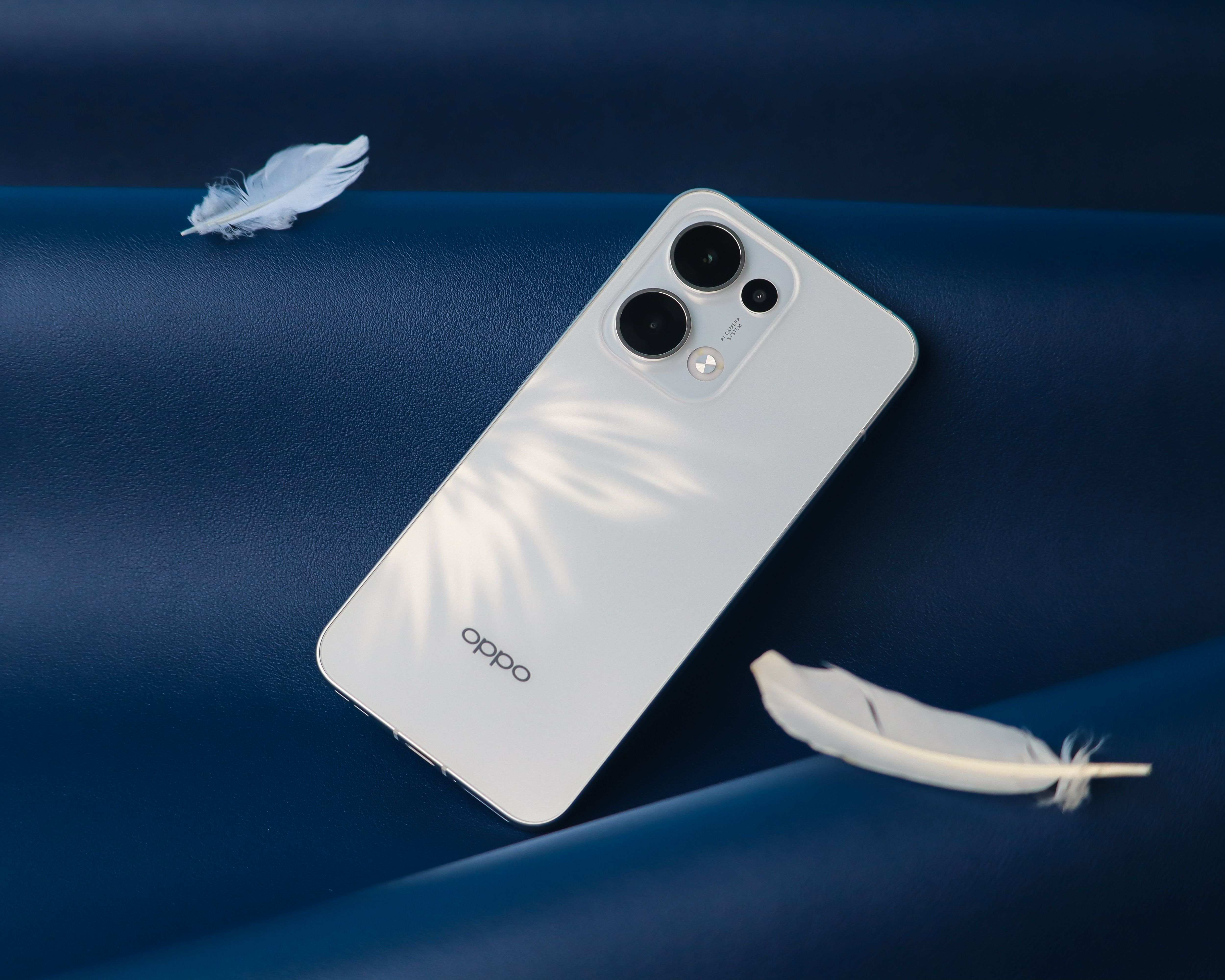 Sleek White Smartphone on Blue Surface · Free Stock Photo