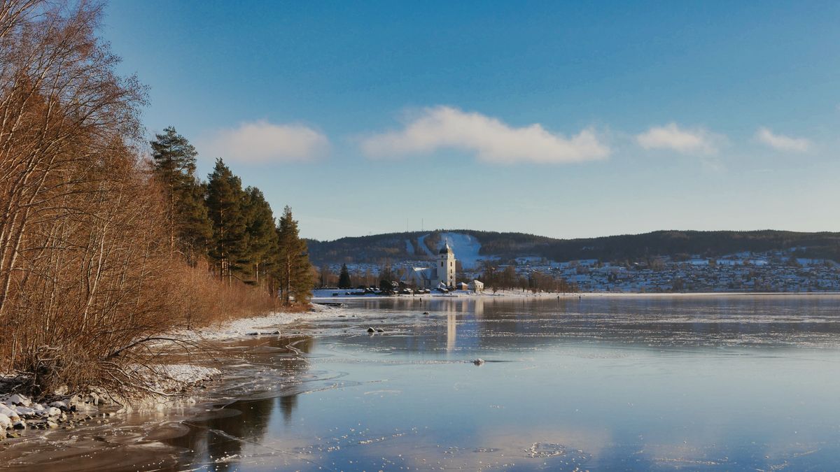 Winter in Rättvik, Dalarna — the frozen lake Siljan, snow-covered hills and the church that has stood on this shore since the 13th century