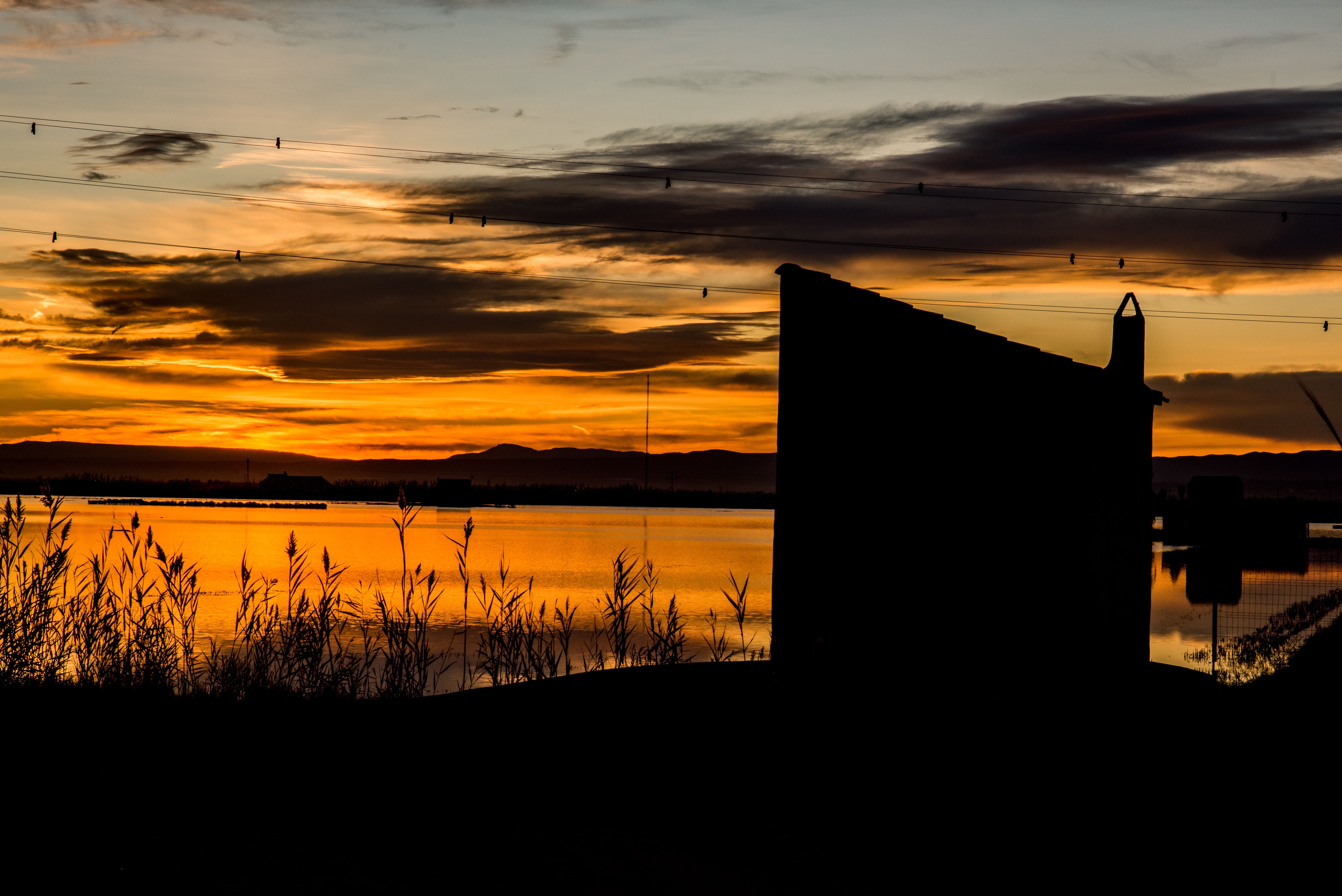 Scenic Sunset Over Tranquil Waters With Silhouette · Free Stock Photo