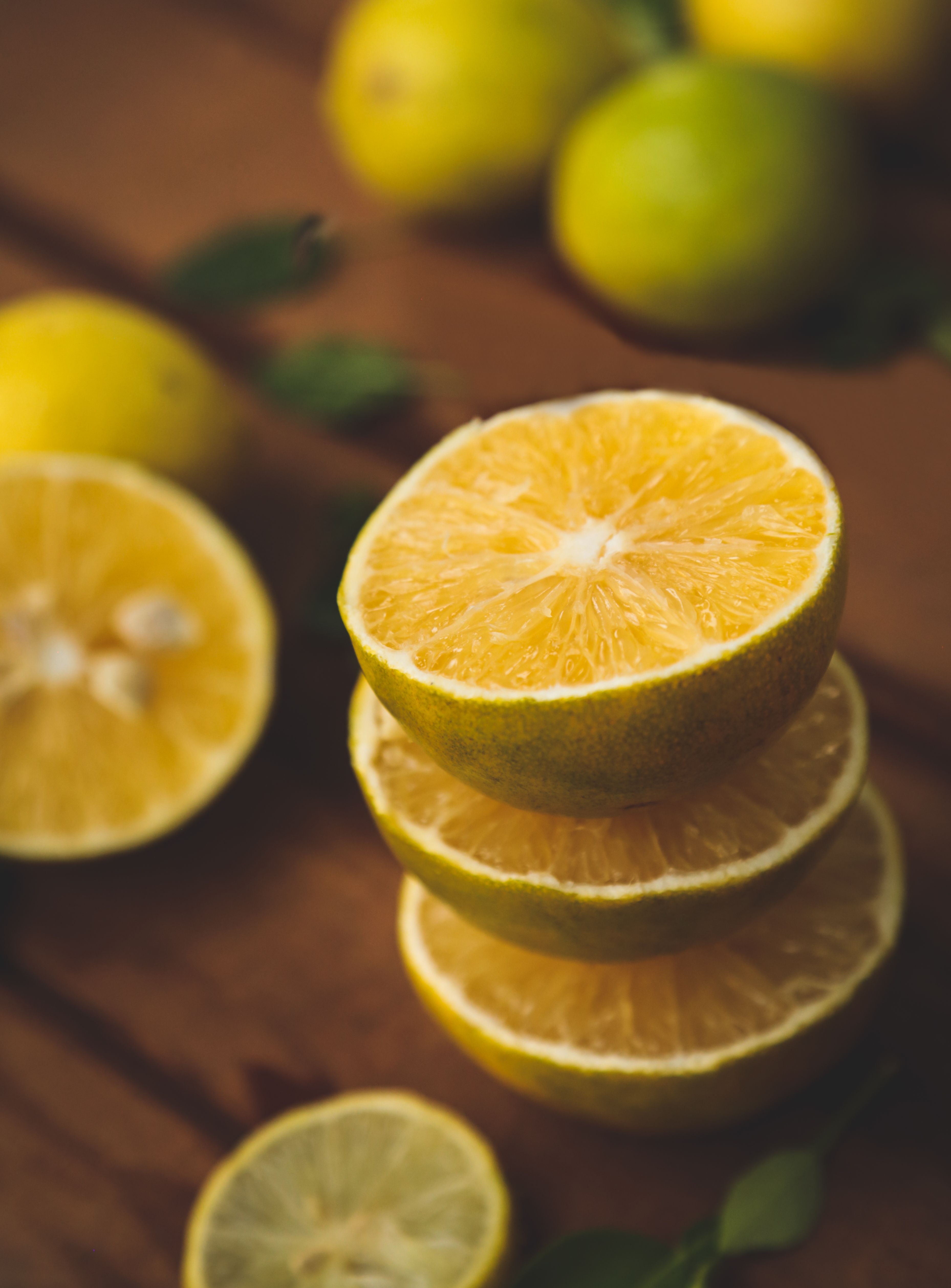 Stack of fresh lemon slices on a wooden background, conveying a refreshing summer vibe.
