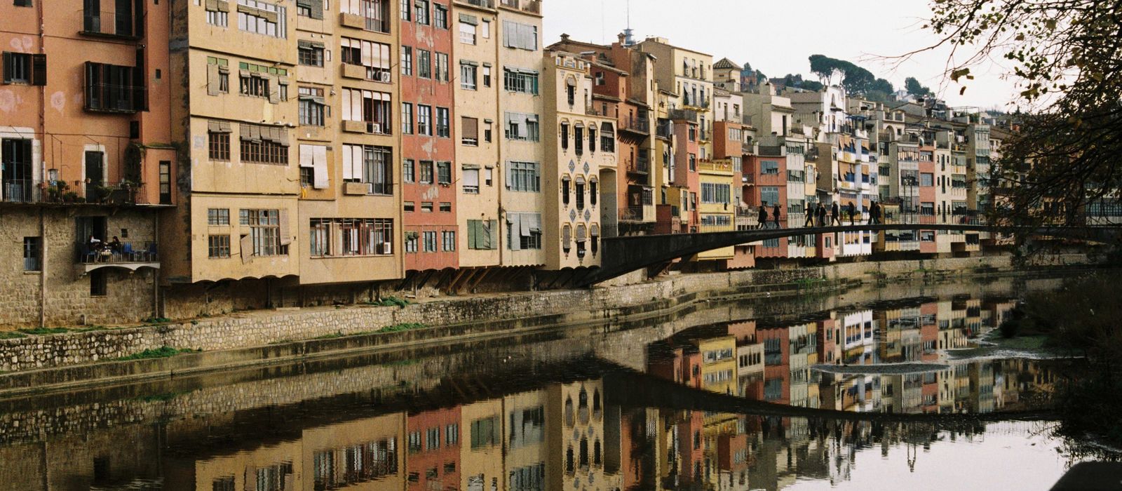 Vibrant historical buildings reflecting in the river in Girona, Catalunya.