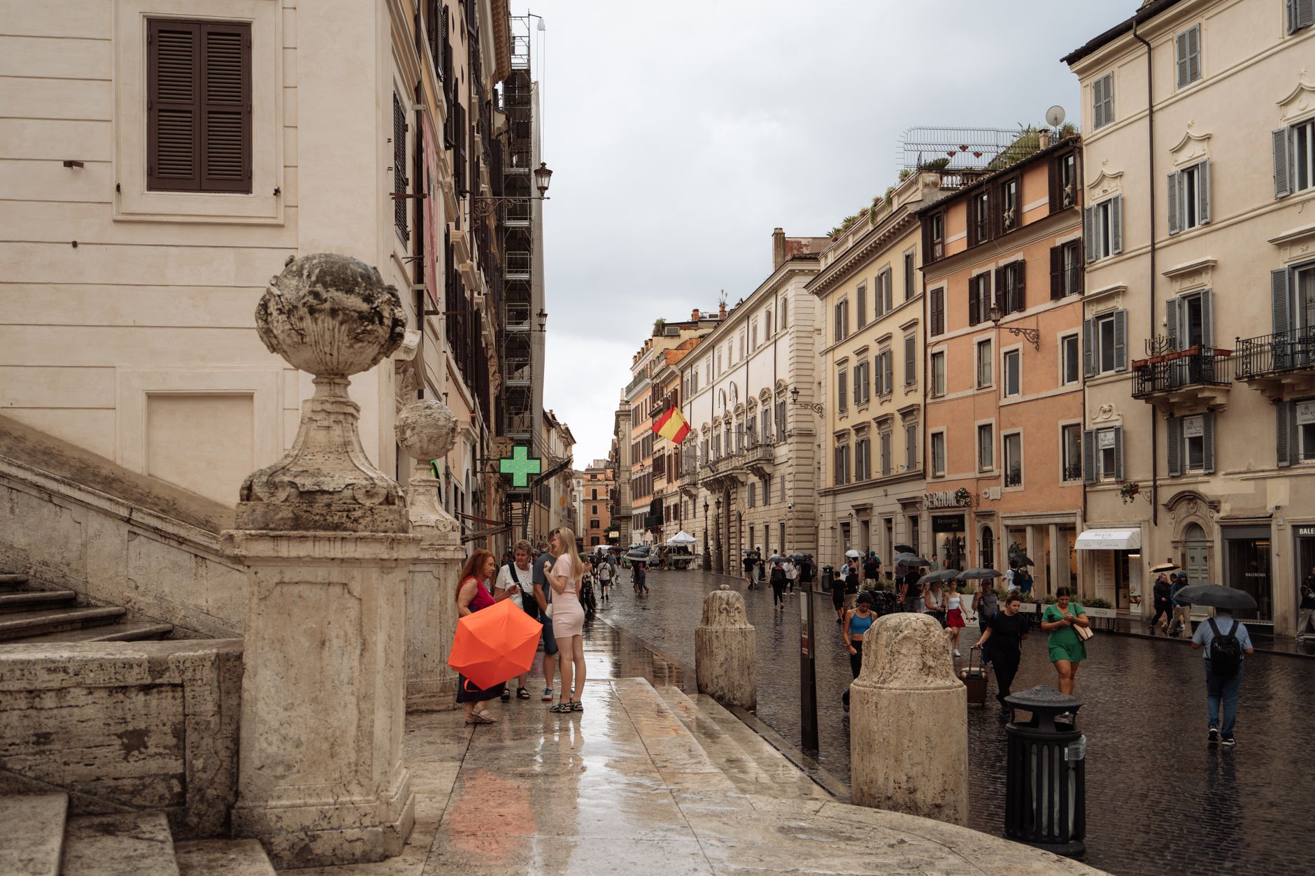 Italian piazza on rainy day with umbrellas