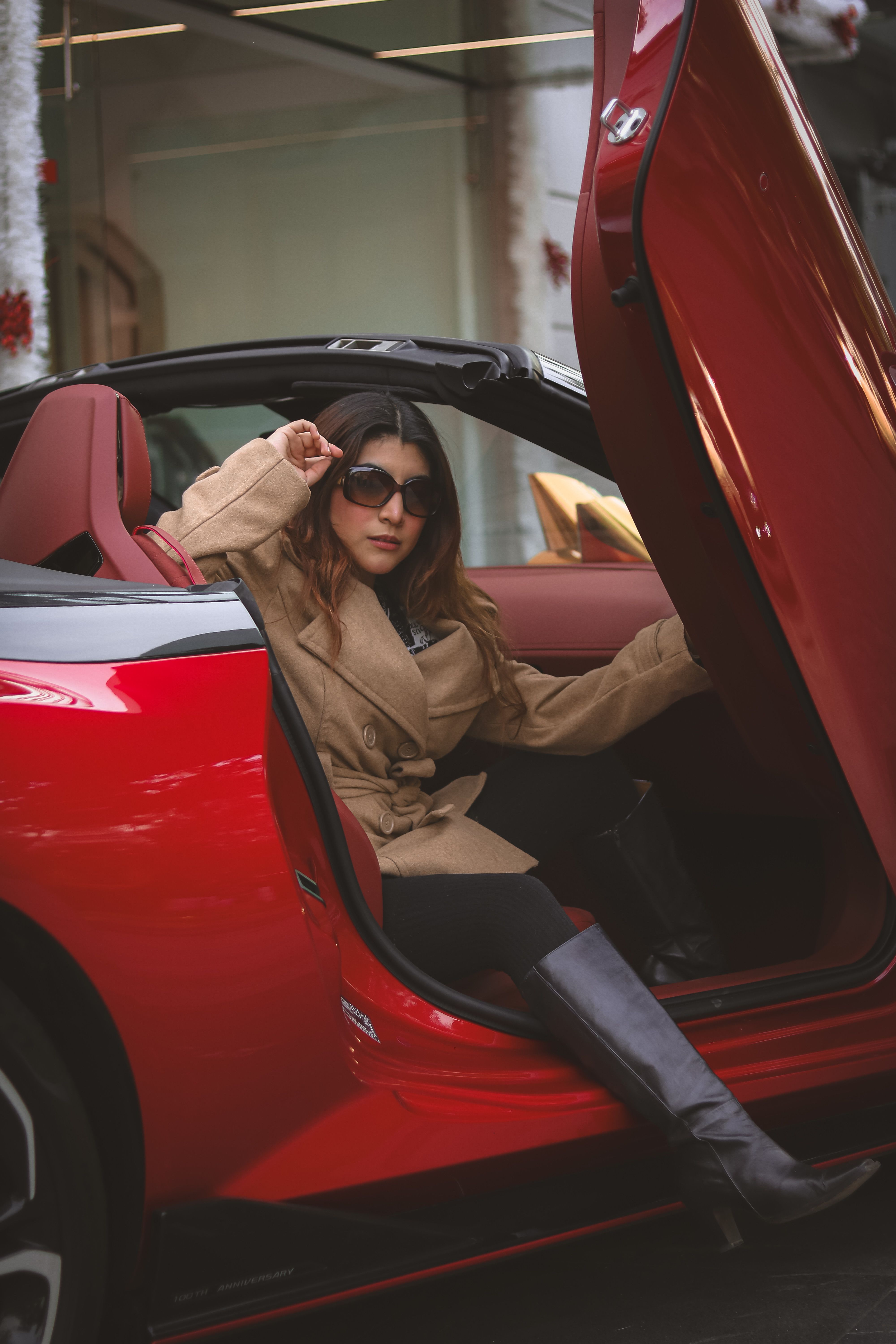 Stylish Woman Exiting Red Convertible Car · Free Stock Photo