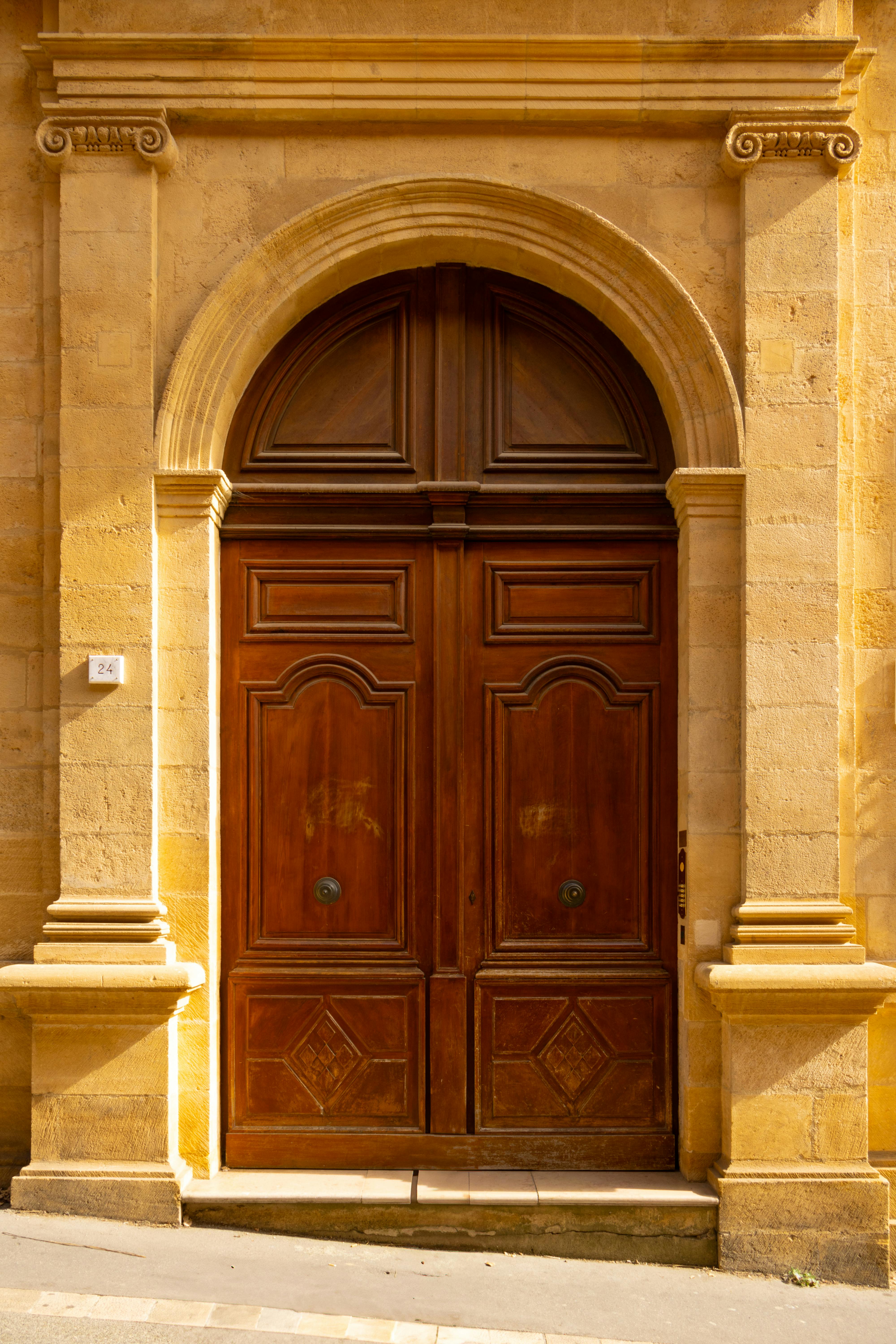 Beautiful rustic wooden doorway in Aix-en-Provence showcasing classic architecture.