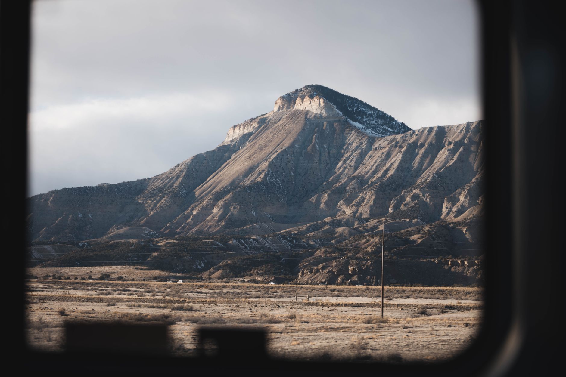 Stunning view of Mount Garfield through a window frame, showcasing rugged natural beauty.