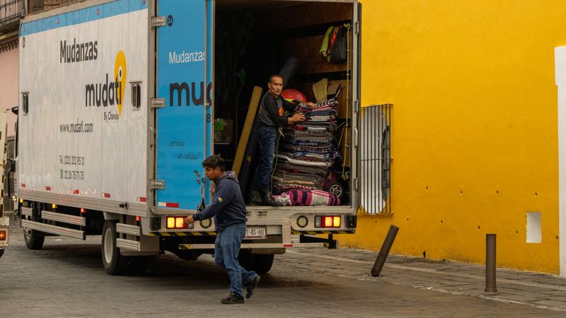 SwiftHaul Moving crew loading household furniture into a moving truck