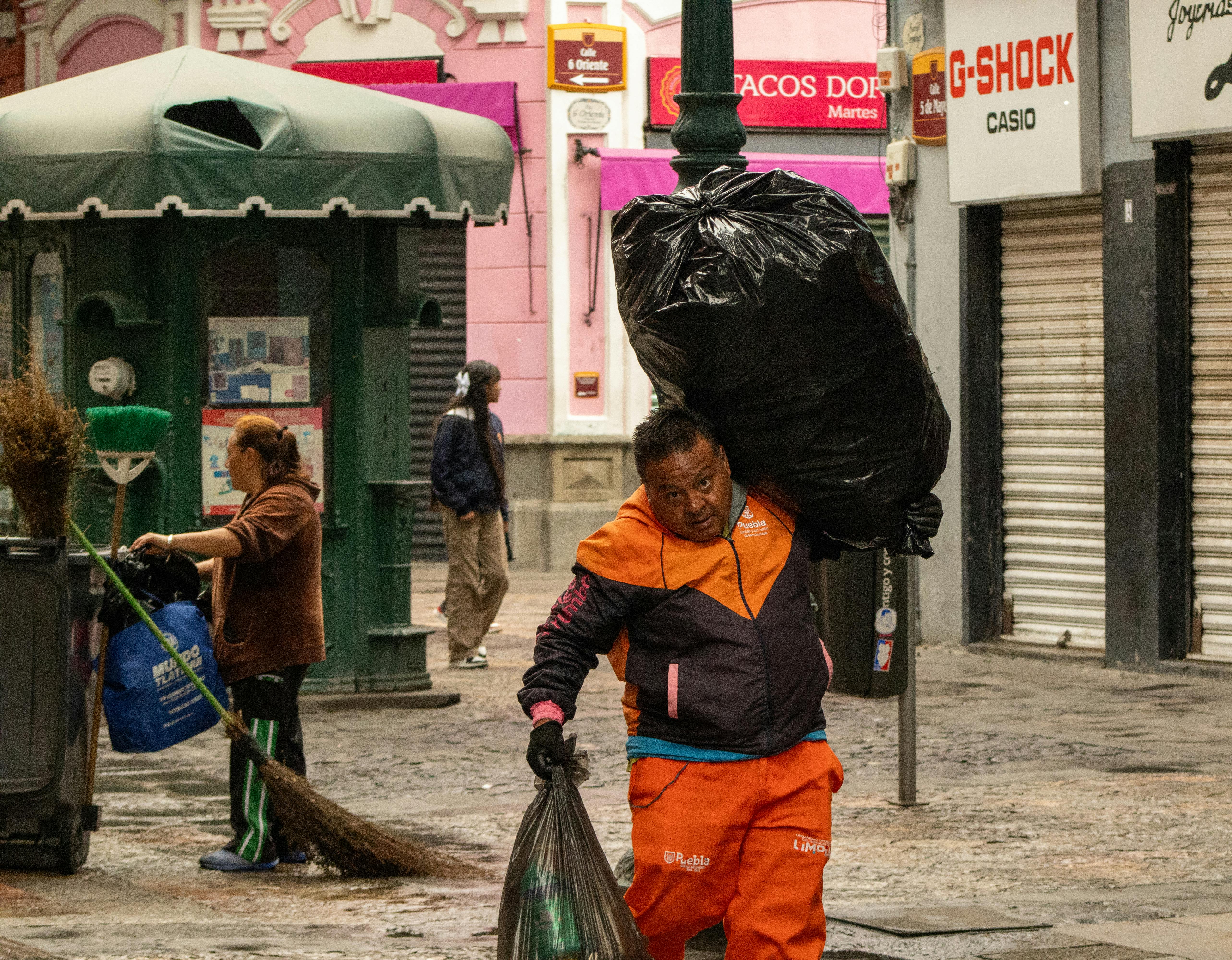Street cleaners working in urban Mexico, capturing daily routine.