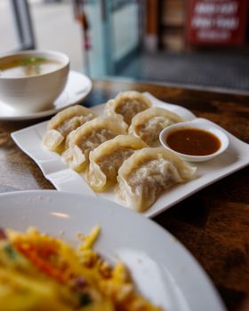 Mouthwatering steamed dumplings served with dipping sauce, perfect for Asian cuisine lovers.