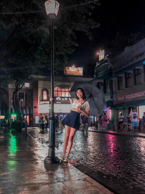 Woman Under Black Umbrella