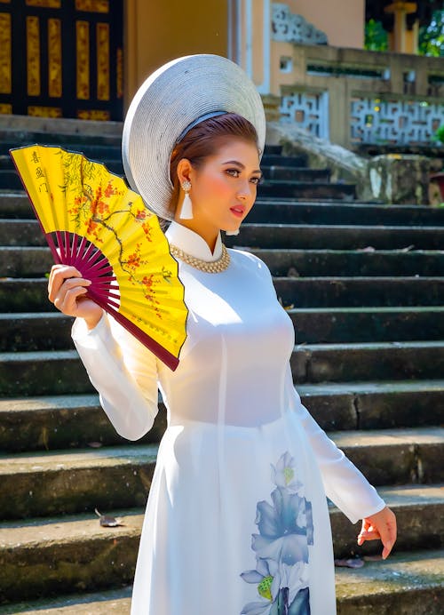Woman In White Dress Holding Hand Fan