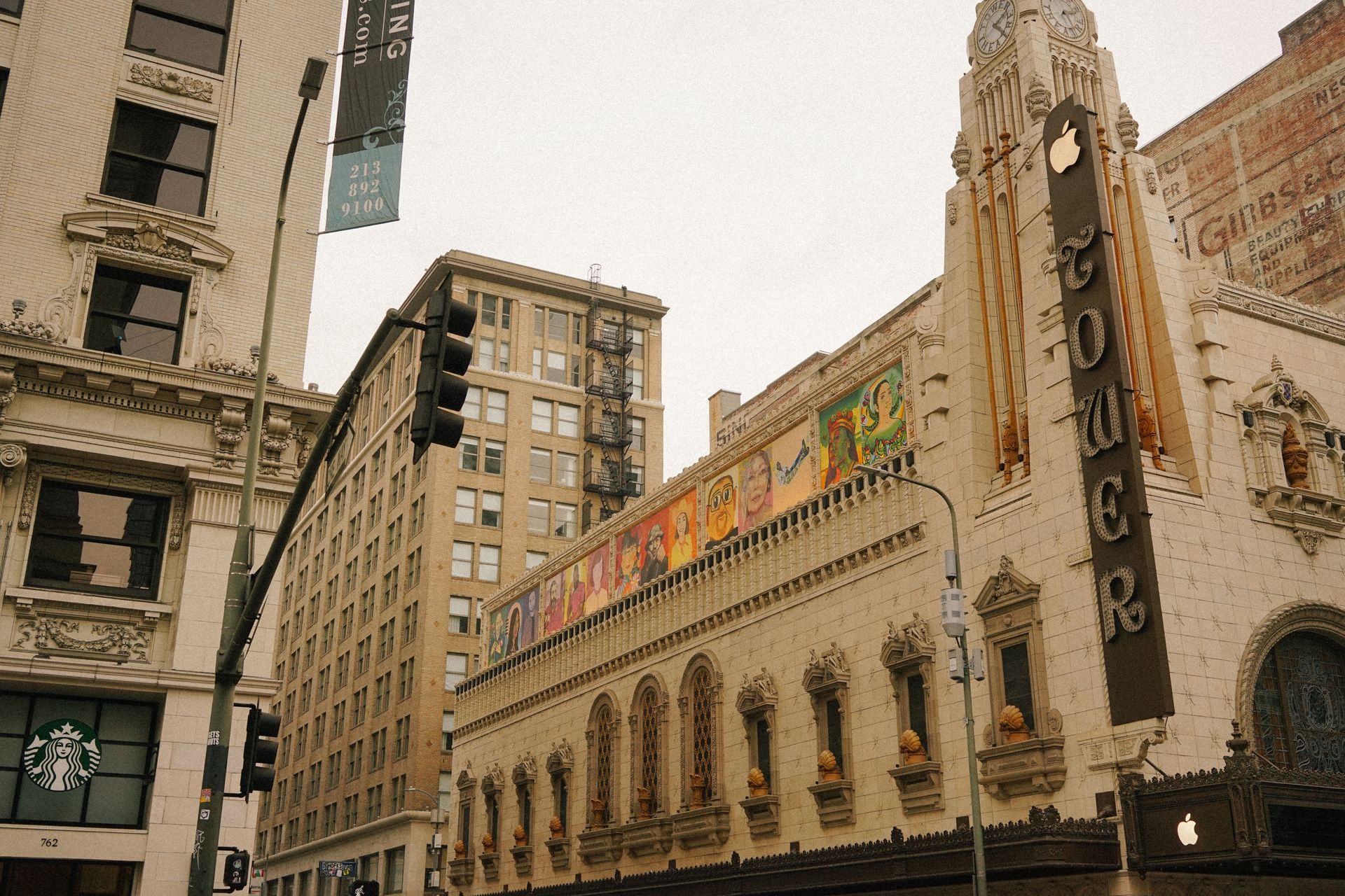 Urban scene featuring a historic theater with intricate architecture and street view.