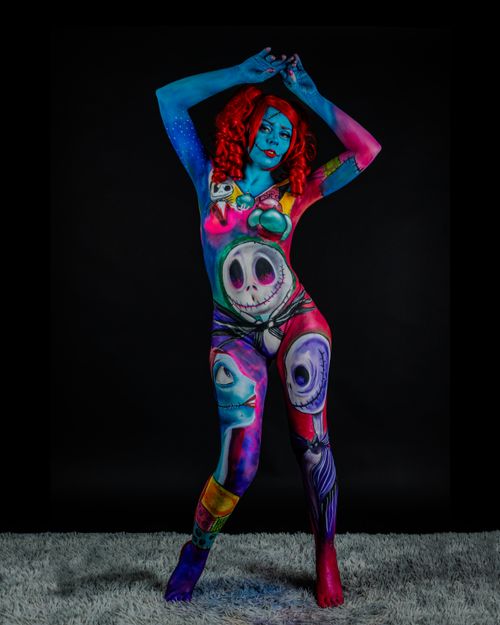 Free Explore surreal makeup and body art on a model embracing empowerment in a vivid and colorful setting. Stock Photo