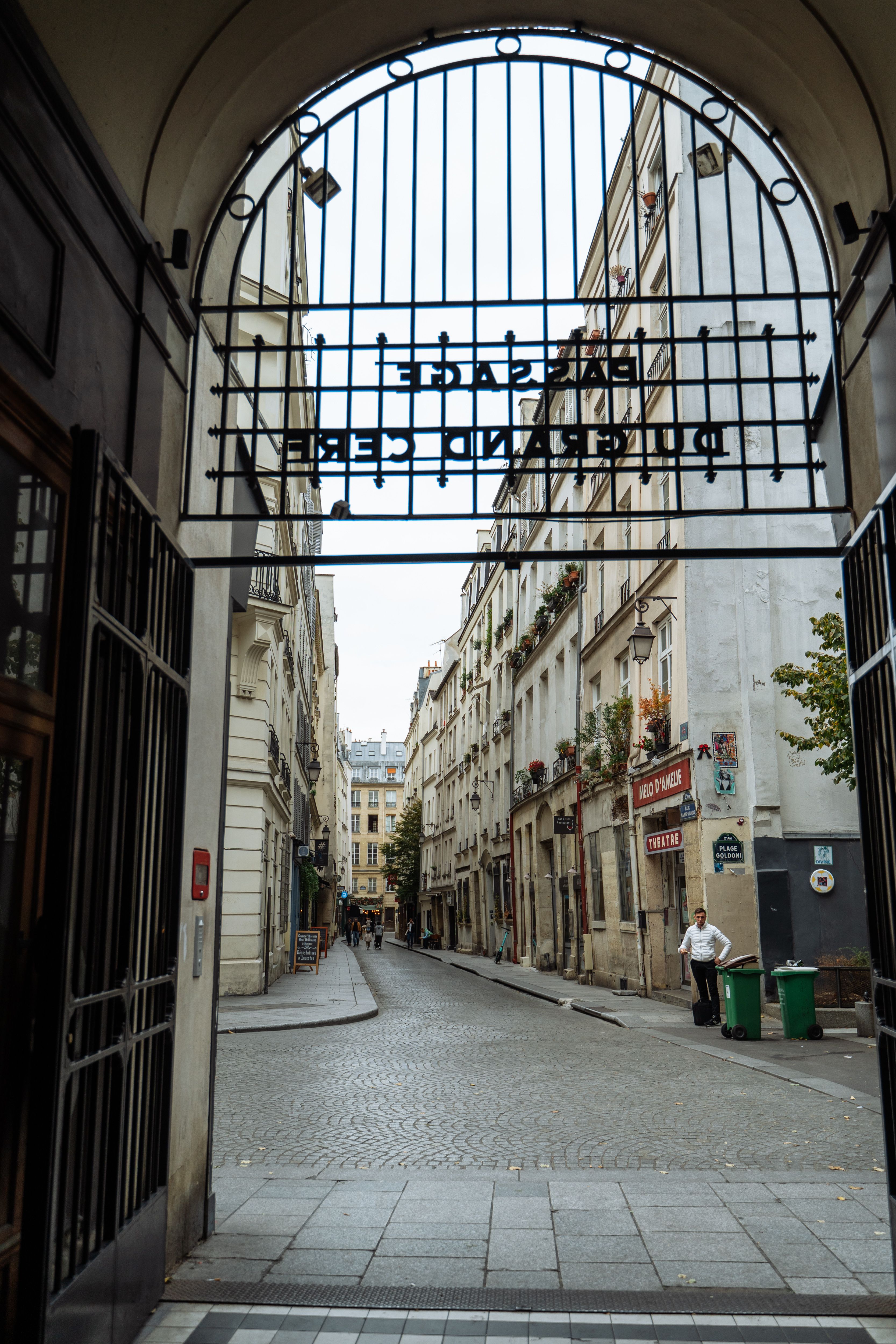 Charming Parisian Street Through Ornate Archway · Free Stock Photo
