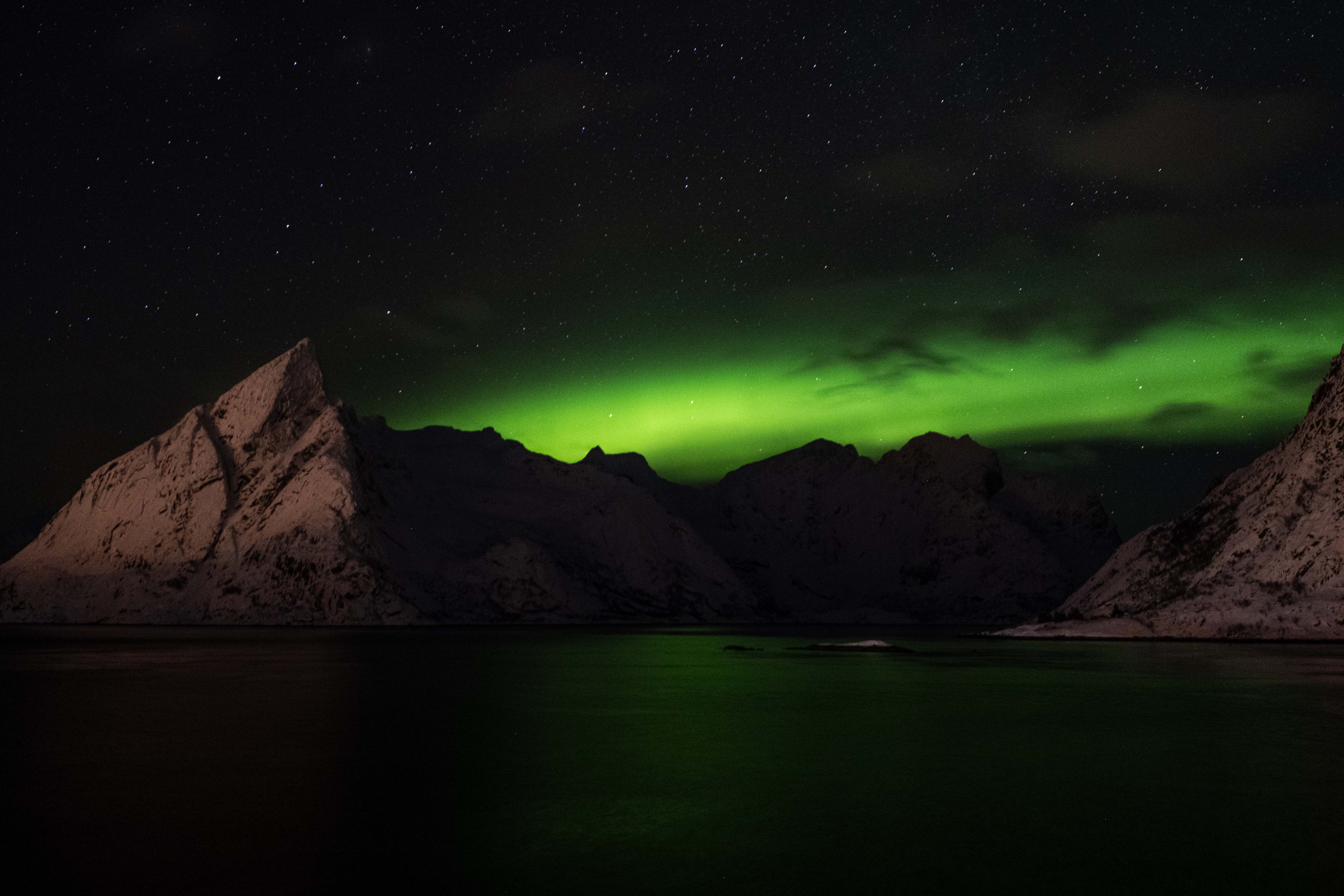 Northern Lights Over Snowy Mountains at Night · Free Stock Photo