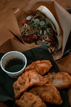 A tempting display of bao and crispy gyoza with dipping sauce in Amsterdam.