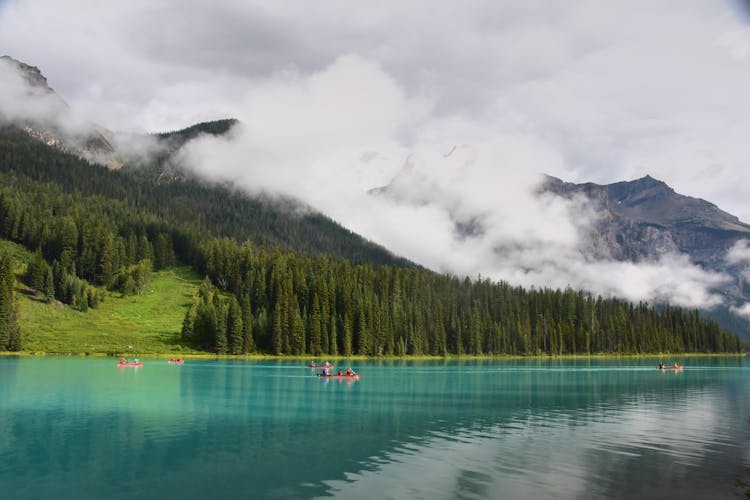 People Riding Boat On Lake