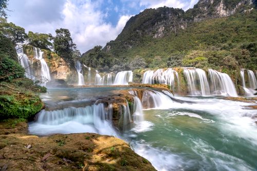 Free Stunning waterfall cascading through lush greenery, showcasing natural beauty and tranquility. Stock Photo