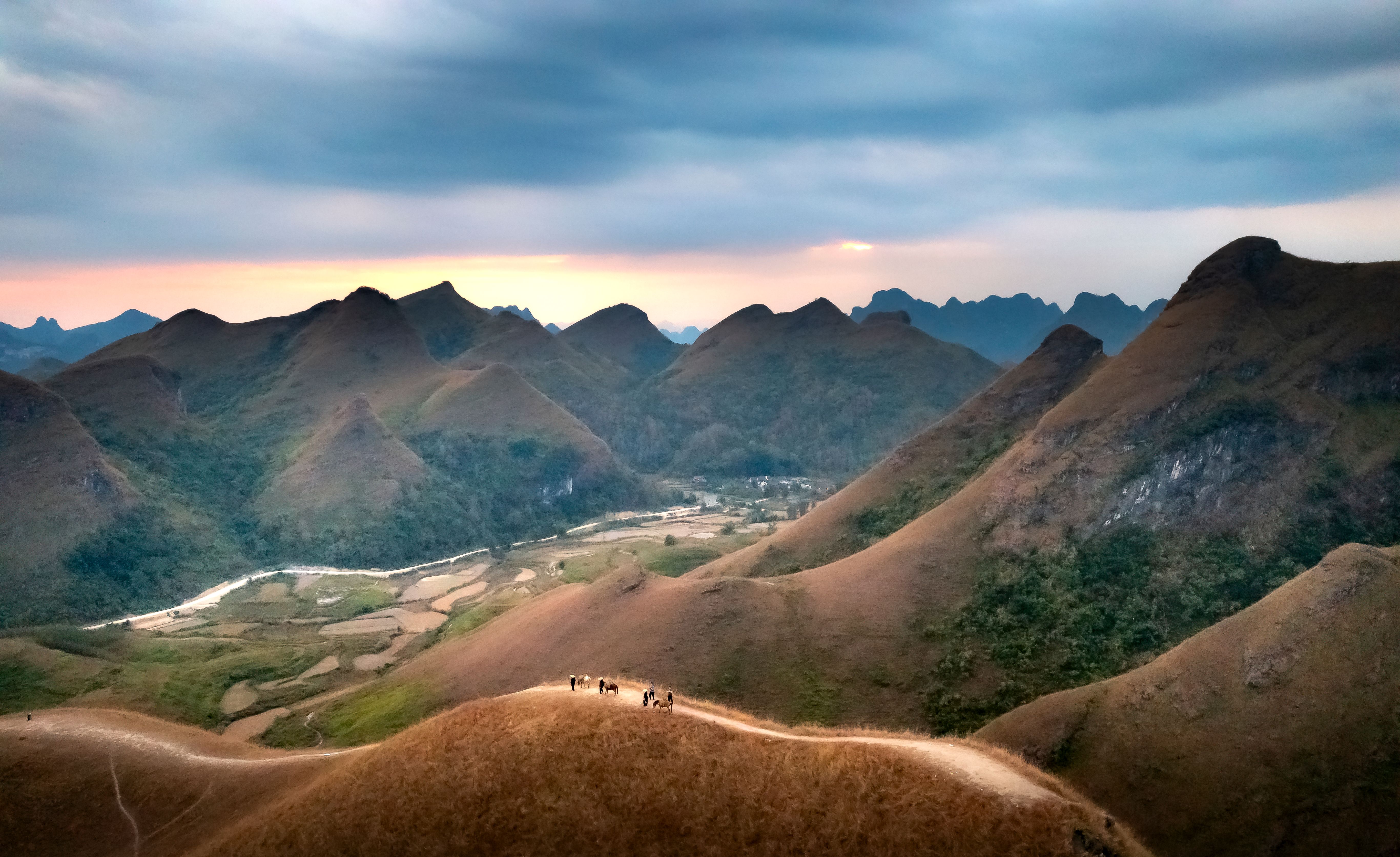Hiking group on mountain ridge at sunset