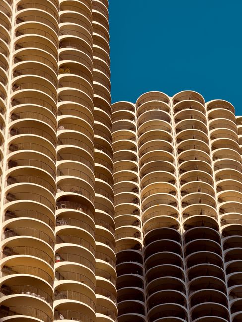 Close-up view of iconic circular high-rise architectural facade with clear sky background.
