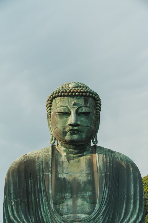 Free Close-up of the Great Buddha of Kamakura against a cloudy background. Stock Photo