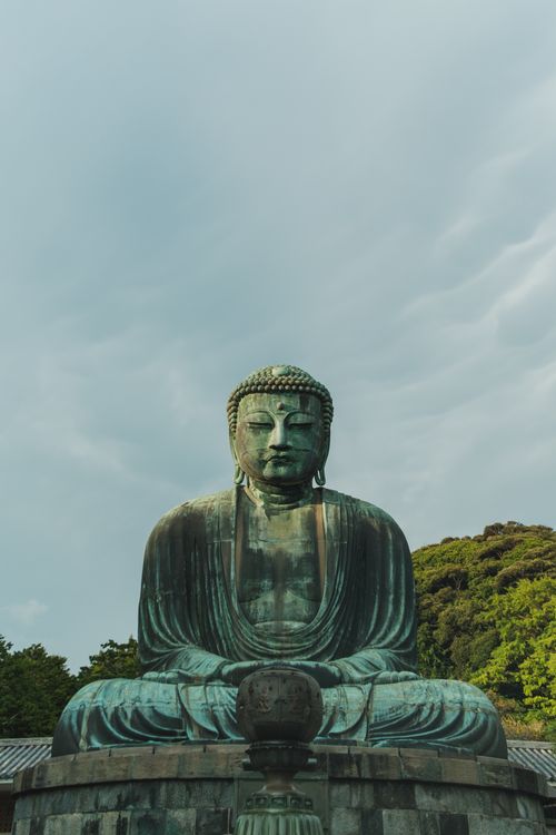 Free A serene view of the Great Buddha statue in Kamakura against a clear sky. Stock Photo