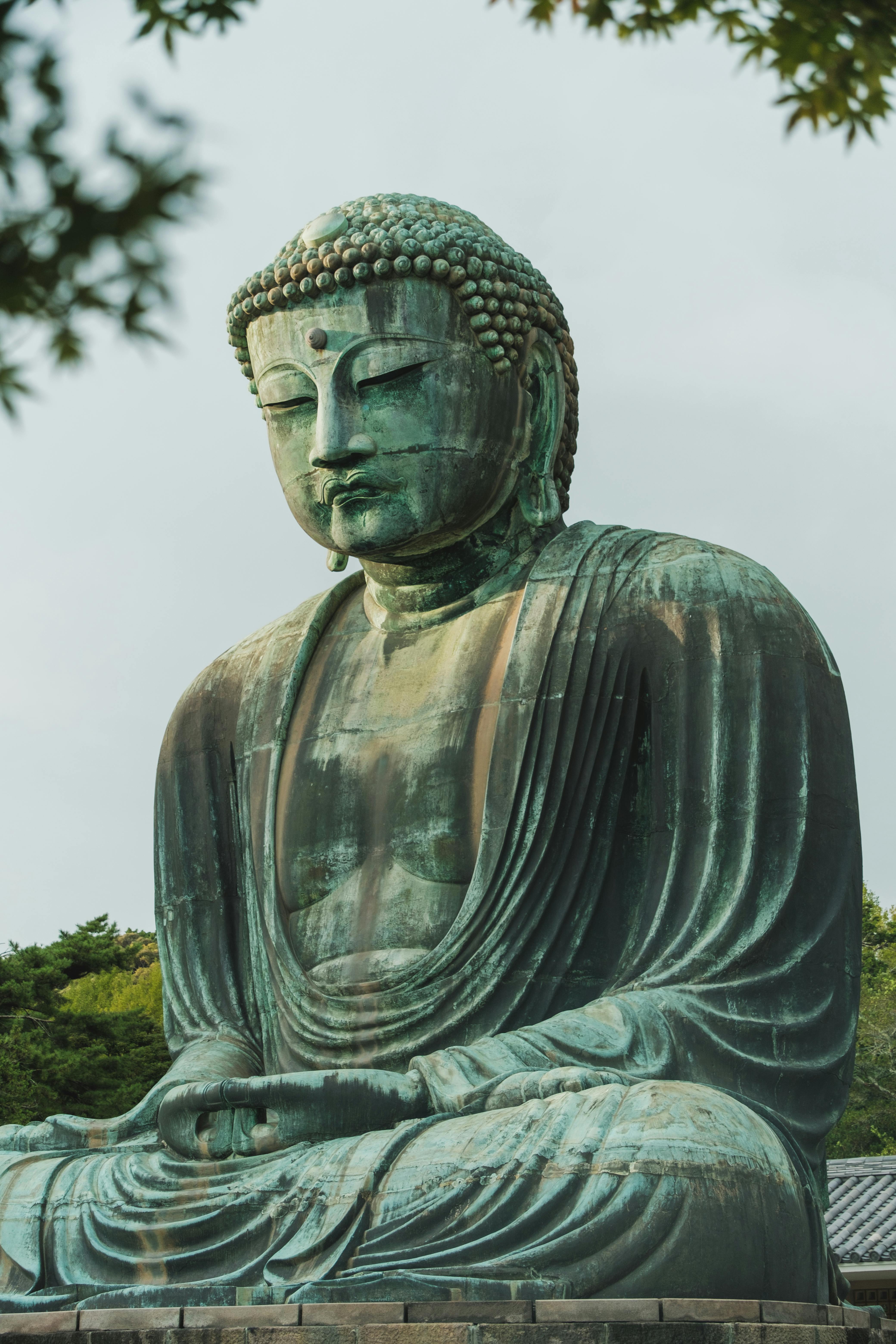 Free The iconic Great Buddha statue at Kamakura, showcasing serene expression and intricate details. Stock Photo