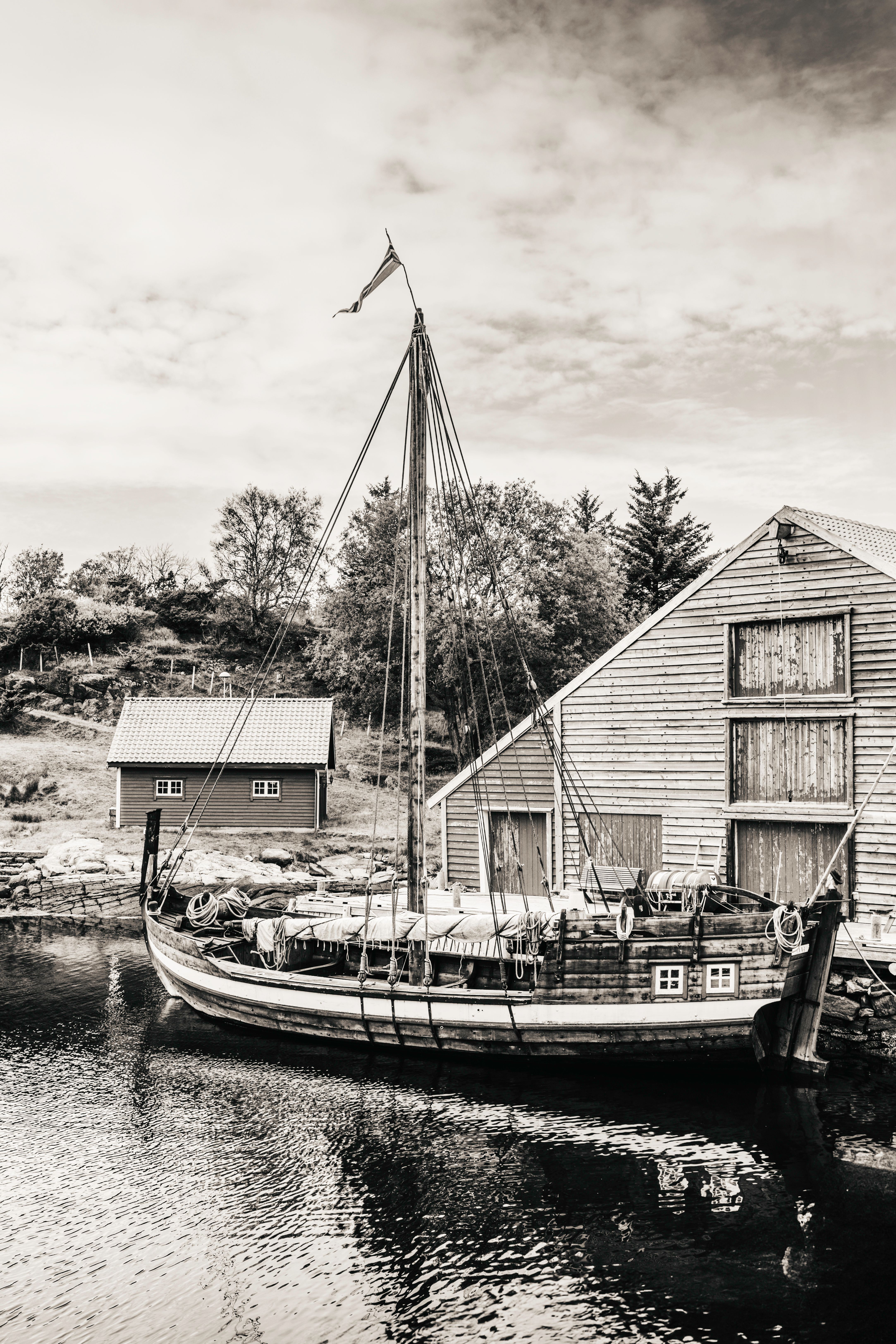 Vintage Ship Docked by Rustic Nordic Boathouse · Free Stock Photo
