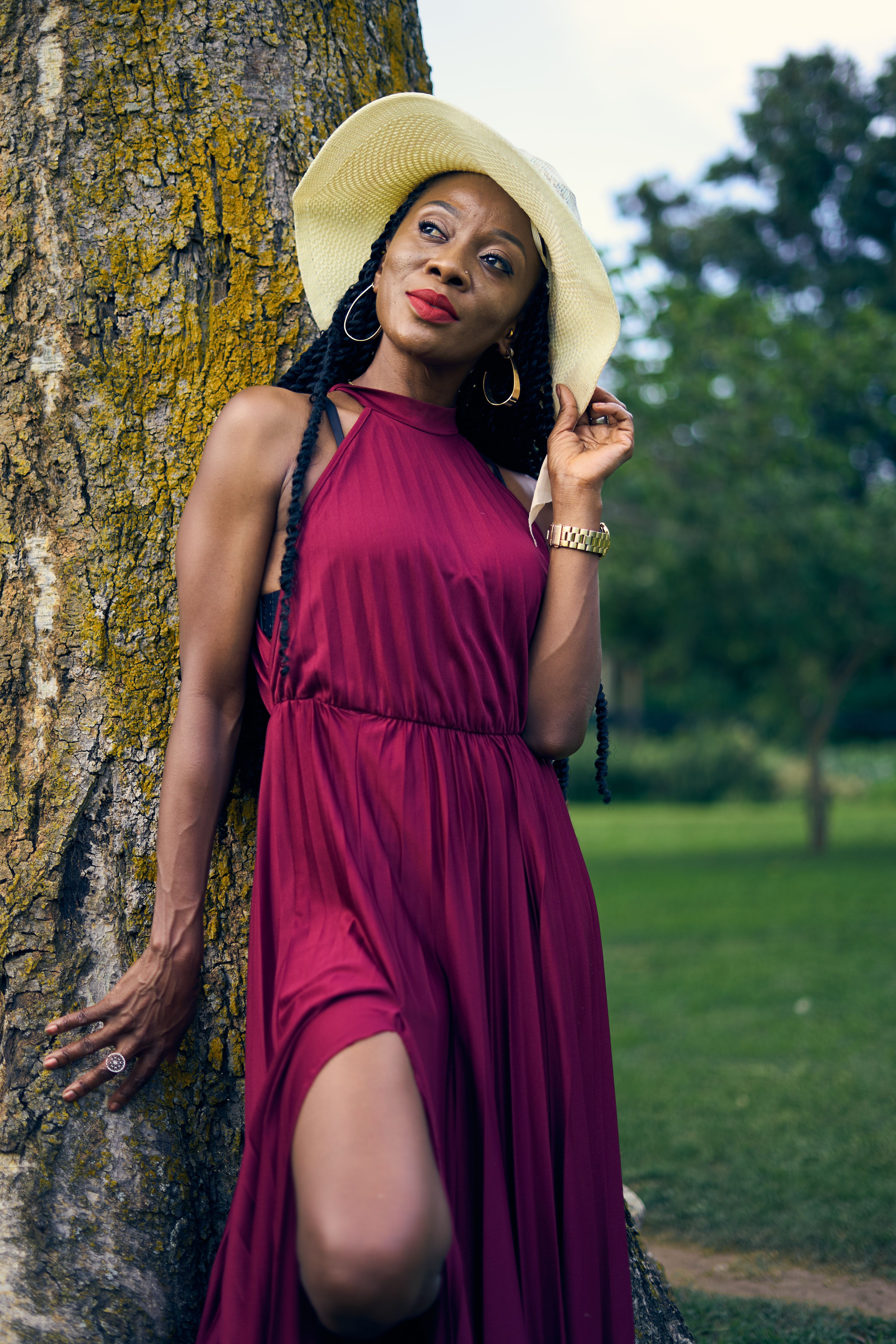 Elegant Woman Posing in Burgundy Dress Outdoors · Free Stock Photo