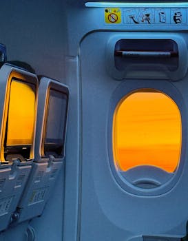 Stunning sunrise seen through airplane window, enhancing travel experience.