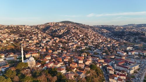 Free Drone shot of densely packed houses on the hillsides of Istanbul at sunset. Stock Photo