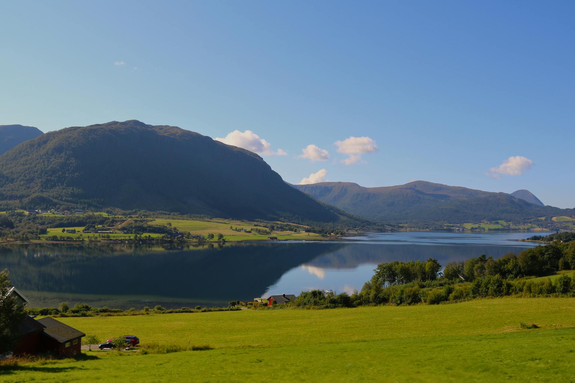 Beautiful summer landscape of Norwegian fjords reflecting in a tranquil lake near Bergen.