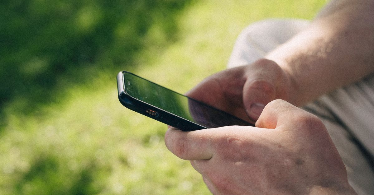 Close-up of Hands Using Smartphone Outdoors · Free Stock Photo