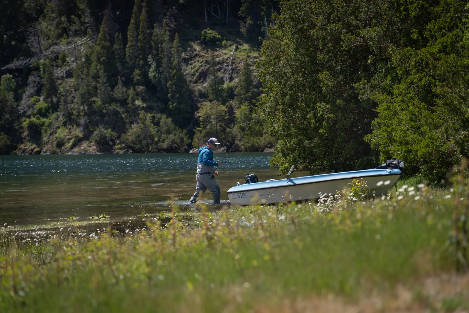 A man fly fishing by a calm lake in Patagonia, Argentina. A man fly fishing by a calm lake in Patagonia, Argentina.