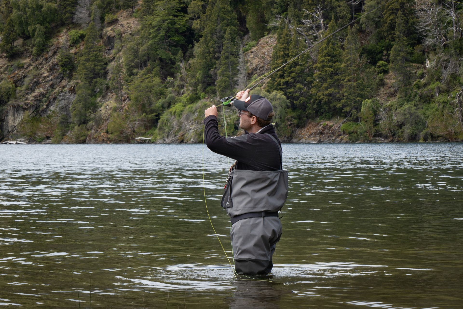 A man fly fishing in the serene rivers of Patagonia, ideal for adventure seekers.