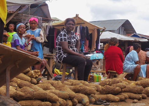A bustling local market showcasing vendors and customers with fresh produce in Africa.