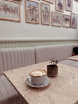 A latte in a cozy cafe with minimalist decor, perfect for a relaxing coffee break.
