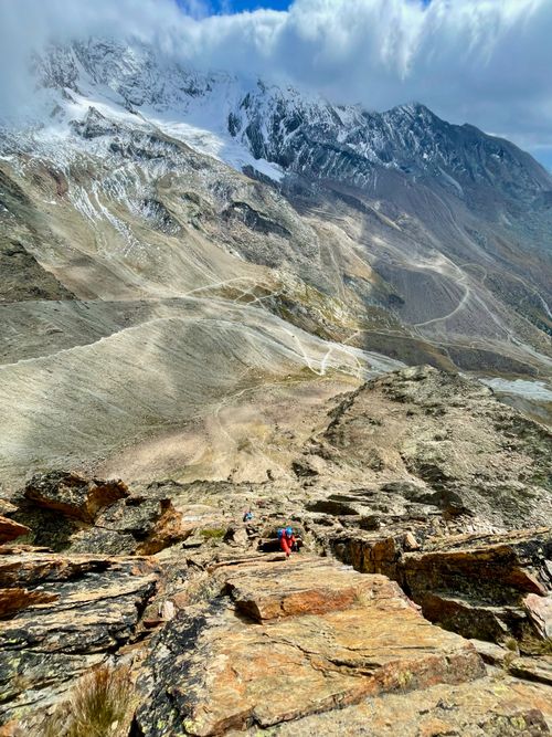 Free Scenic view of hikers ascending rocky mountain in Saas-Grund, Swiss Alps. Stock Photo