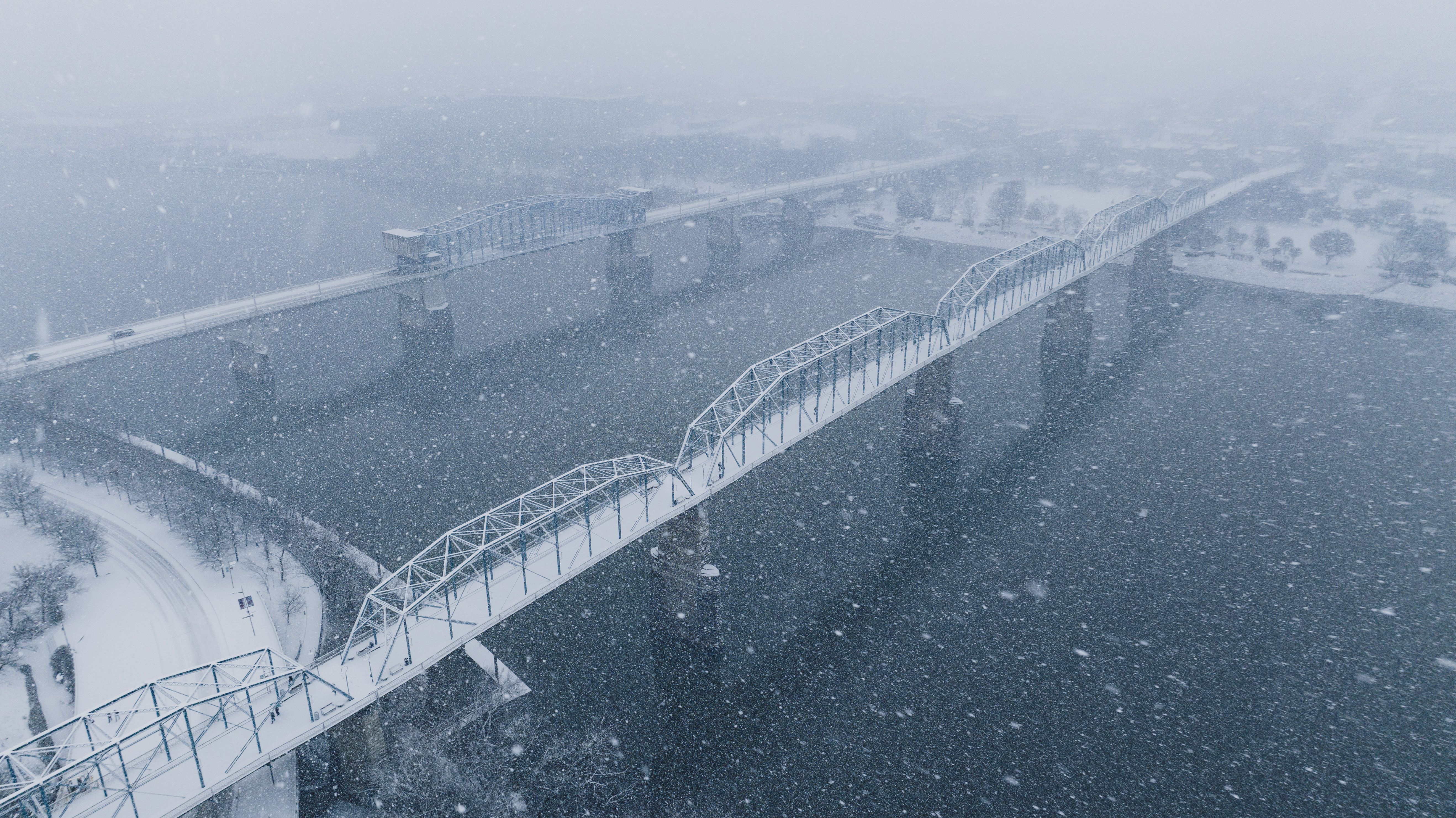Snowy Bridge Over River in Winter Storm · Free Stock Photo