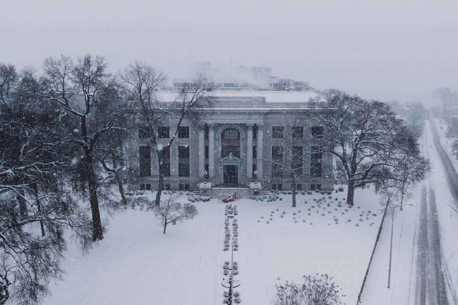 Historic courthouse blanketed in snow, captured on a serene winter day.
