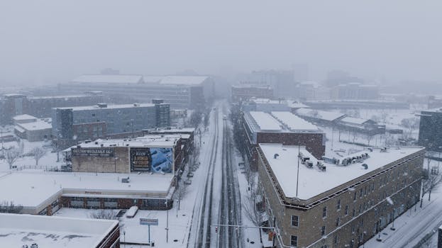 Aerial shot of Chattanooga city in heavy snowfall depicting a winter urban landscape.