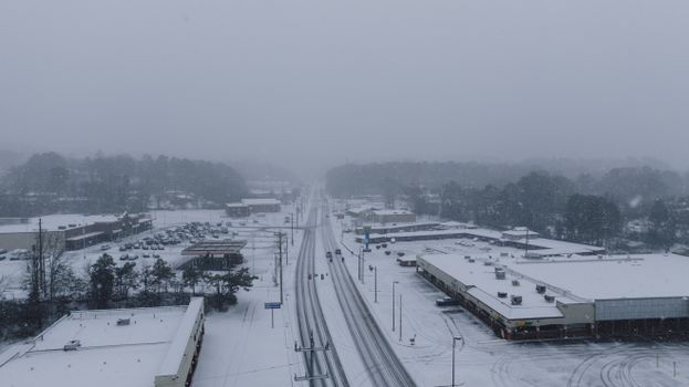 Aerial view of a snow-covered cityscape in Tennessee during winter.