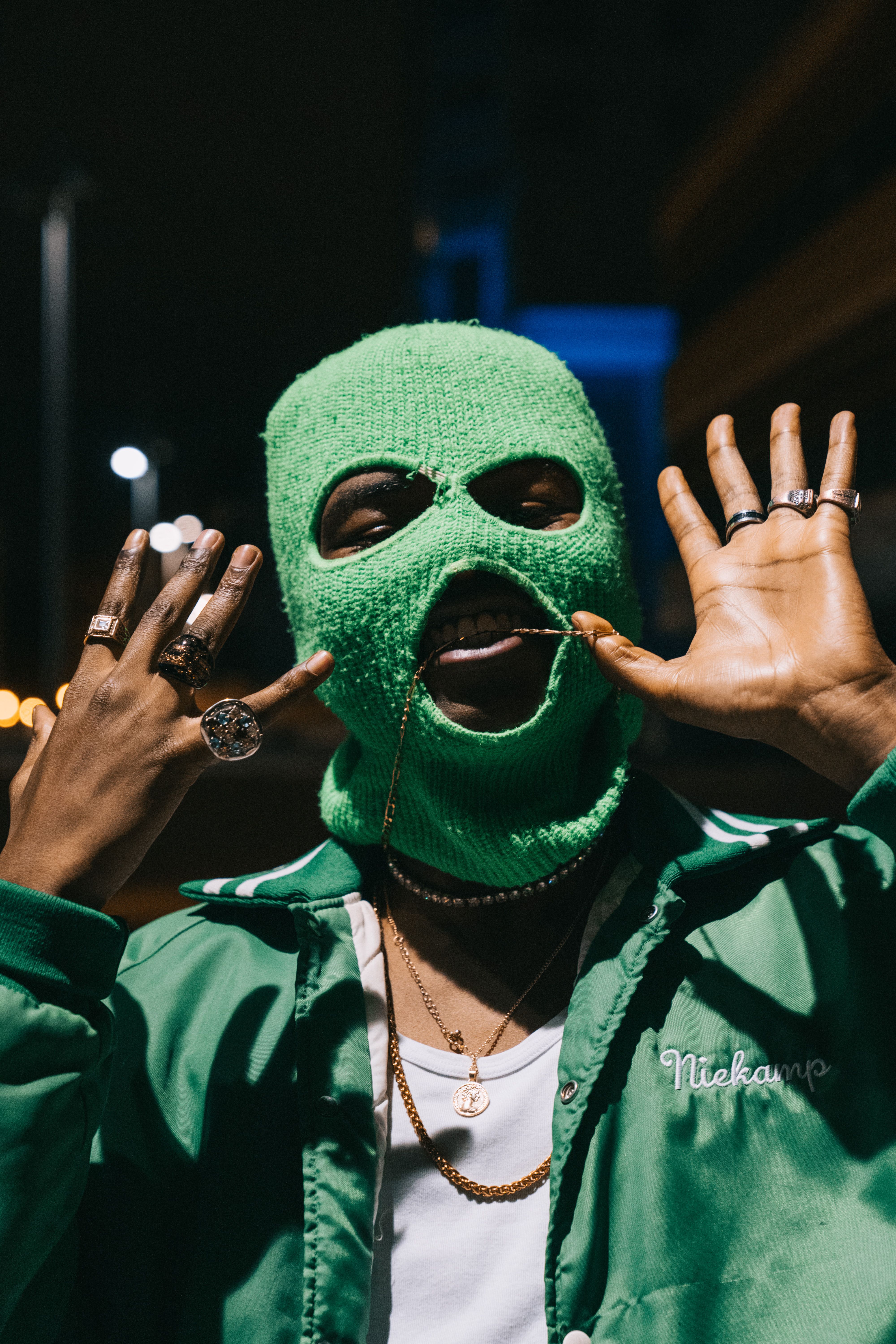 Stylish Individual in Green Balaclava at Night · Free Stock Photo