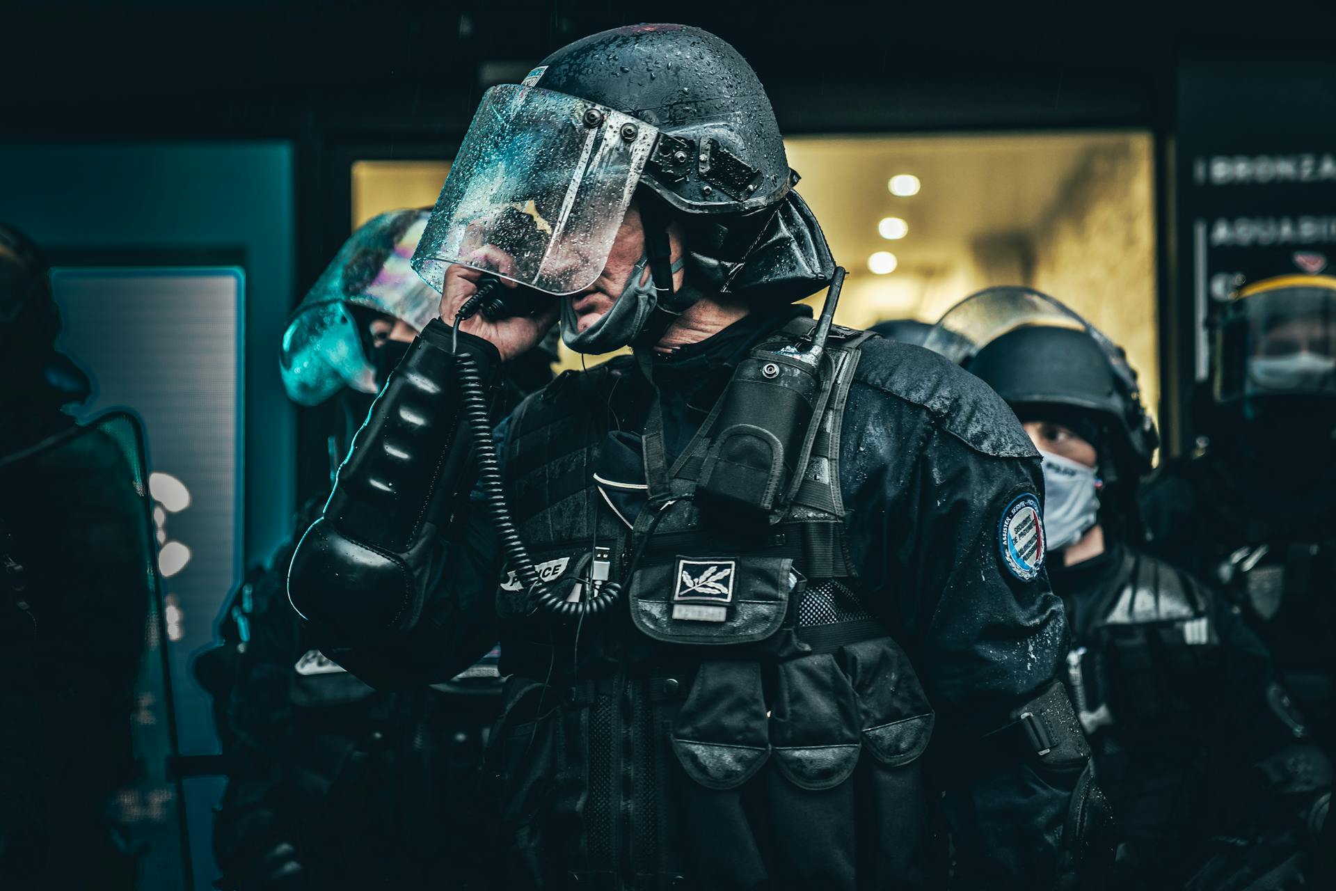 Police officers in tactical gear communicating during an operation in Paris.